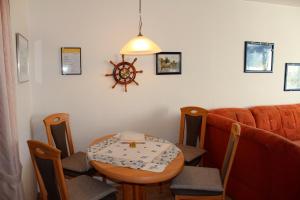 a small dining room with a table and chairs at Hinzberg, P-EG-4 in Heiligenhafen