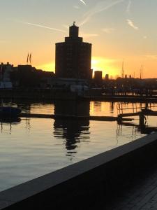 a sunset over a body of water with a city at Gode Wind in Eckernförde