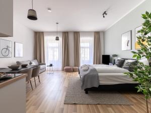 a bedroom with a bed and a living room at limehome Villach Kirchenplatz in Villach
