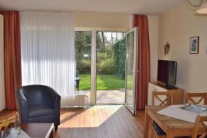 a living room with a sliding glass door to a yard at Am Hof 1 unten in Staberdorf