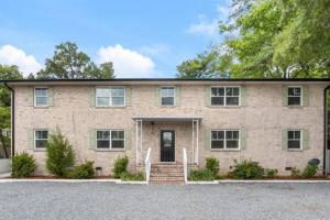 a large brick house with a driveway at Lake Life A - 2 Bdrm Sleeps 4 - 5 Min Walk to Beach & Downtown Acworth - 10 Min to Lake Point Sports Complex in Acworth