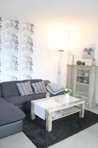 a living room with a couch and a coffee table at Ferienwohnung Steffens - "Lübecker Straße" in Grömitz