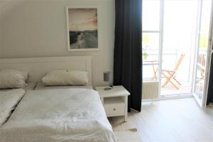 um quarto com uma cama, uma mesa e uma janela em "Pappelhof - Whg 10" em Grömitz