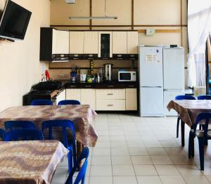 a kitchen with two tables and a refrigerator at ШарЛООтка in Loo