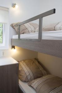 two bunk beds in a room with a window at Chalet bis 6 Personen ohne Hund - a17103 in Flüthörn