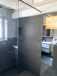 y baño con ducha acristalada y lavamanos. en Käpt`n Suite, en Papenburg