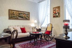 a living room with a couch and a table and chairs at Classic Apartments in Old Town in Tallinn