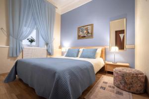 a bedroom with a bed and a chair and a window at Classic Apartments in Old Town in Tallinn