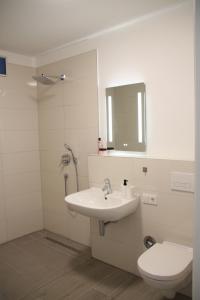 a bathroom with a sink and a toilet at Casa Kronengarten Nr 4 in Hilden