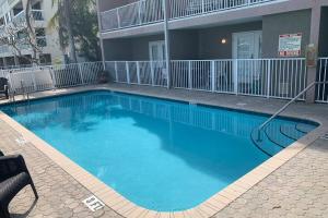 a large blue swimming pool in front of a building at Luxury and Spacious Waterside Getaway in Clearwater Beach