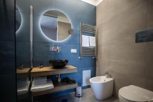 a bathroom with a sink and a toilet and a mirror at L'élégant BOUTIQUE ROOMS NAPLES in Naples +26 photos