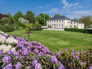 a large house with flowers in front of it at Backhaus West in Bisdorf
