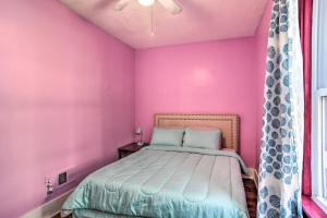 a bedroom with pink walls and a bed at Riverside Buffalo Apt 15 Miles to Niagara Falls! in Buffalo