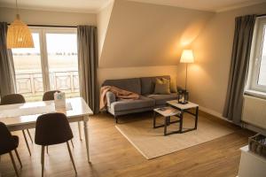 ein Wohnzimmer mit einem Sofa und einem Tisch in der Unterkunft FerienDüne 1 in Kägsdorf