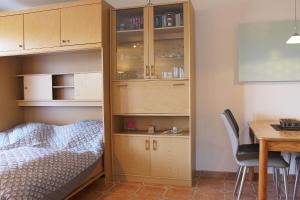 a bedroom with a bed and a cupboard and a table at Ferienwohnung Baumert in Grömitz