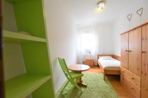 a small room with a table and a green wall at Haus Lotti - a27182 in Kellenhusen