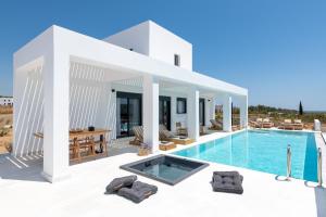 a villa with a swimming pool and a house at Seacarf Villa, 3 magnificent properties in Lachania beach, Bedrooms 12, Sleeps 27 in Lachania