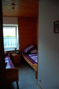 - une petite chambre avec 2 lits et une fenêtre dans l'établissement Ferienwohnung Cantay - Nr1, à Fehmarn