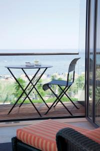 a glass table and a chair on a balcony at Albatros in Haffkrug