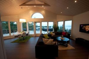 a living room with a couch and a table at Svinö Waterfront Villa in Lumparland