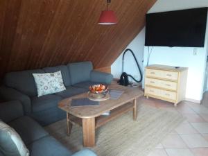 a living room with a couch and a table at Landhaus-Marwede App 5 in Haffkrug