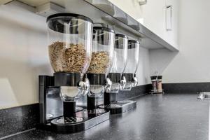 a row of wine glasses on a kitchen counter at Emerald En-suite in Derby in Derby