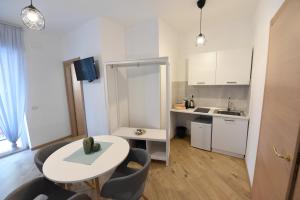 a small white kitchen with a table and chairs at Geordie's in Potenza