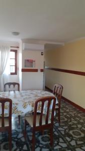 a dining room with a table and four chairs at Bienestar Duplex in Gualeguay