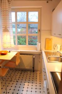 a small kitchen with a table and a sink at Finke-Ferienhaus - EG in Grömitz