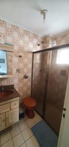 a bathroom with a shower with a toilet and a sink at Guaruja ap lindo 200 m da praia in Guarujá