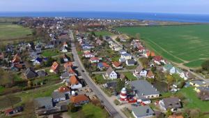 an aerial view of a small town next to the ocean at Ferienhaus Leuchtturm in Börgerende-Rethwisch