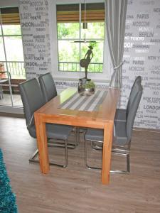 a dining room table with four chairs around it at "Landhaus Voss" Typ 4 Nr12 in Staberdorf