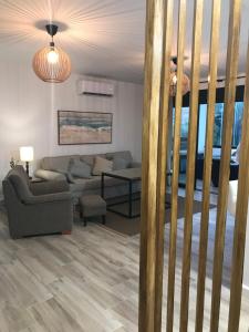 a living room with a couch and a table at APARTAMENTO ZAHARA DE LOS ATUNES ATLANTERRA in Zahara de los Atunes