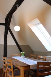 a dining room with a table and a skylight at Bauernhof Höpner "Im Backhaus" in Vadersdorf