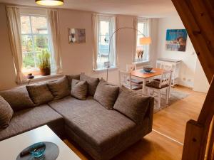a living room with a couch and a table at UsedomTor 1720 FeWo II in Wolgast