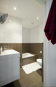 a bathroom with a sink and a toilet and a mirror at Adam & Eve - Apartment in Amsterdam