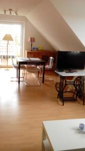 ein Wohnzimmer mit einem Klavier und einem Tisch in der Unterkunft Am Norderfeld 17 in Großenbrode