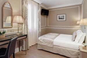 Postel nebo postele na pokoji v ubytování Hotel Nuovo Teson