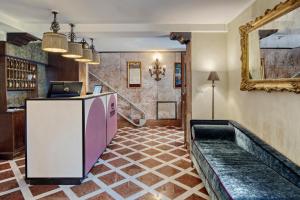 a lobby with a pink refrigerator and a mirror at Hotel Nuovo Teson in Venice