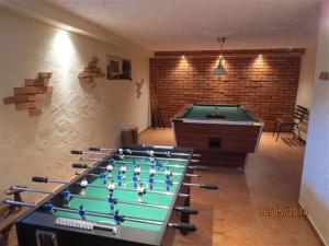 a room with a pool table and a brick wall at Cudodomek na Mazurach w Woszczelach koło Ełku in Ełk