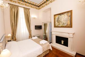 Ένα ή περισσότερα κρεβάτια σε δωμάτιο στο Palaiologos Luxury City Hotel