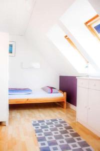 a bedroom with a bed in a attic at Haus Sonnenschein in Dänschendorf