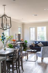 a living room with a table and a blue couch at HISTORIC 2 Story Near DTLA/USC/LAFC/STAPLES CENTER in Los Angeles