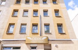 a building with a sign in front of it at Hotel-Pension ODIN in Berlin
