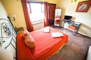 a bedroom with a red bed and a window at Hotel Campanilla in Ushuaia