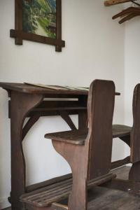 un tavolo in legno con sedia e una foto sul muro di Fewo Bubenberg a Bad Berleburg