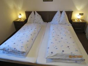 a white bed with two pillows on it in a bedroom at Villa Löcker 3 in Mariapfarr