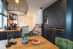 a kitchen with a wooden table with food on it at Superior - a57363 in Bad Segeberg