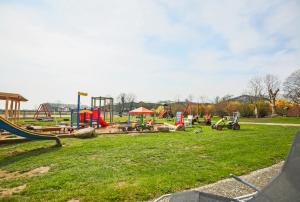a park with a playground with a slide at Ferienhof Büdlfarm - Treckerschuppen in Sahrensdorf