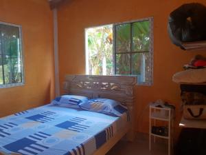 1 dormitorio con cama y ventana en Cabaña cerca al mar - A 200 mts, en Coveñas